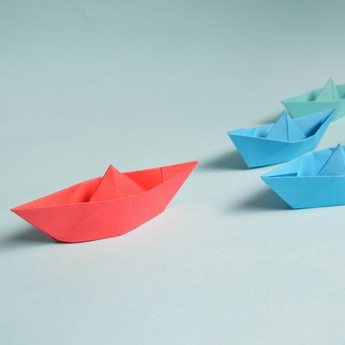 a group of paper boats sitting on top of a table